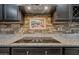 Gourmet kitchen features a modern cooktop and custom backsplash at 18495 W Rimrock St, Surprise, AZ 85388
