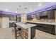 Modern kitchen with granite countertops, pendant lights and stainless appliances at 18495 W Rimrock St, Surprise, AZ 85388
