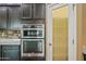 Modern kitchen with stainless steel appliances and a pantry door at 18495 W Rimrock St, Surprise, AZ 85388