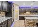 Chef's kitchen boasts granite counters, double ovens, and modern cabinetry at 18495 W Rimrock St, Surprise, AZ 85388