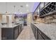 Open concept kitchen with stainless steel appliances and stone backsplash at 18495 W Rimrock St, Surprise, AZ 85388