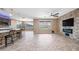 Open living room with a breakfast bar, fireplace, lots of natural light, and access to the backyard at 18495 W Rimrock St, Surprise, AZ 85388