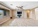 Open living room features a fireplace, a ceiling fan, and view of the patio at 18495 W Rimrock St, Surprise, AZ 85388