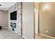 Stylish living room with stone accent wall, electric fireplace, and modern design at 18495 W Rimrock St, Surprise, AZ 85388