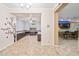Open-concept living space with easy access to the kitchen and den with custom built-ins and desk at 18495 W Rimrock St, Surprise, AZ 85388