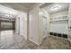 Hallway featuring view into living room and hallway with mudroom entrance at 18495 W Rimrock St, Surprise, AZ 85388