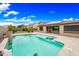 Spacious pool with solar panels, rock features, and desert landscaping at 18495 W Rimrock St, Surprise, AZ 85388