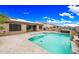Inviting backyard pool with tanning shelf, spa, and patio perfect for outdoor relaxation and entertainment at 18495 W Rimrock St, Surprise, AZ 85388