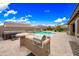 Backyard pool area featuring a built-in grill and desert landscaping at 18495 W Rimrock St, Surprise, AZ 85388