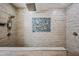 Modern shower with wood tile, rainfall shower head, handheld shower, and mosaic tiled niche at 18495 W Rimrock St, Surprise, AZ 85388