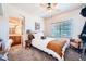 This bedroom features an en-suite bathroom, natural light, neutral tones, and comfortable furniture at 19834 W Minnezona Ave, Litchfield Park, AZ 85340