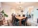 Cozy dining room with decorative chandelier and a rustic wooden table with leather chairs at 19834 W Minnezona Ave, Litchfield Park, AZ 85340