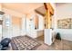 Stylish entryway with a rustic wooden door, a decorative rug, and custom light fixtures, creating a warm welcome at 19834 W Minnezona Ave, Litchfield Park, AZ 85340