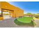 This detached Casita features a covered patio and a private putting green at 19834 W Minnezona Ave, Litchfield Park, AZ 85340