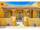 Charming front entrance with tiled roof, wooden columns, and decorative accents at 19834 W Minnezona Ave, Litchfield Park, AZ 85340