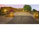 Stunning home featuring colorful flowering bushes, mature trees, and a long driveway at 19834 W Minnezona Ave, Litchfield Park, AZ 85340
