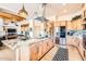 Modern kitchen features a large center island, stainless steel appliances, and custom wood cabinetry at 19834 W Minnezona Ave, Litchfield Park, AZ 85340