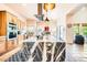 Open kitchen showcasing a large center island, modern appliances, and stylish pendant lighting at 19834 W Minnezona Ave, Litchfield Park, AZ 85340