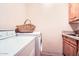 The home features a functional laundry room with a sink, counter space, and tile floors at 19834 W Minnezona Ave, Litchfield Park, AZ 85340
