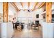 Spacious living room boasting high ceilings with exposed wood beams, a cozy fireplace, and tile flooring at 19834 W Minnezona Ave, Litchfield Park, AZ 85340