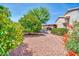 Lush desert landscaping and a covered patio create a private and inviting backyard oasis at 20215 N Mariposa Way, Surprise, AZ 85374