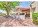 Backyard with covered patio featuring outdoor seating and low-maintenance desert landscaping, perfect for relaxing outdoors at 20215 N Mariposa Way, Surprise, AZ 85374