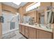 Spacious bathroom featuring double sinks, ample counter space, and glass shower enclosure at 20215 N Mariposa Way, Surprise, AZ 85374