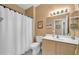 Well-lit bathroom with a shower-tub combo, vanity with a sink, and neutral-toned decor at 20215 N Mariposa Way, Surprise, AZ 85374