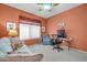 Bright bedroom featuring a sofa, chair, desk with computer, a ceiling fan, and carpeted floors at 20215 N Mariposa Way, Surprise, AZ 85374