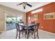 The dining room features a wooden table, tile flooring, and sliding glass doors to the patio at 20215 N Mariposa Way, Surprise, AZ 85374