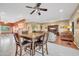 Open-concept dining area adjoining the living room, featuring a dark wooden table and chairs at 20215 N Mariposa Way, Surprise, AZ 85374