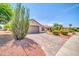 Charming single-story home with a paved driveway and desert landscaping at 20215 N Mariposa Way, Surprise, AZ 85374
