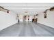 Spacious garage with epoxy floor, storage cabinets, and a laundry area at 20215 N Mariposa Way, Surprise, AZ 85374