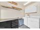 Functional laundry area with a washer, dryer, workbench, and storage cabinets for supplies at 20215 N Mariposa Way, Surprise, AZ 85374