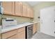 Practical laundry room with plenty of cabinet storage and a sink and wine cooler combo at 20215 N Mariposa Way, Surprise, AZ 85374