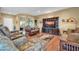 Comfortable living room with hardwood floors, plush furniture, and a large entertainment center at 20215 N Mariposa Way, Surprise, AZ 85374