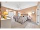 Comfortable main bedroom featuring cozy sitting area and ample natural light at 20215 N Mariposa Way, Surprise, AZ 85374