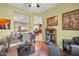 Cozy home office with built-in desk, dark wood furniture, and hardwood floors at 20215 N Mariposa Way, Surprise, AZ 85374