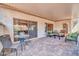 Spacious covered patio with multiple seating areas, perfect for gatherings and enjoying the fresh air at 20215 N Mariposa Way, Surprise, AZ 85374