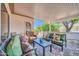 Relaxing covered patio featuring comfortable seating, a coffee table, and serene views of the outdoors at 20215 N Mariposa Way, Surprise, AZ 85374