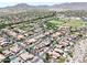 Scenic aerial view of community highlighting mature trees, pools and neighborhood streets at 20615 W Daniel Pl, Buckeye, AZ 85396
