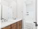 Bright bathroom features a double sink vanity with a quartz counter and walk in shower/tub at 20615 W Daniel Pl, Buckeye, AZ 85396