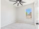 A vacant bedroom with plush carpeting, ceiling fan and natural light from exterior window at 20615 W Daniel Pl, Buckeye, AZ 85396
