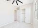 An empty carpeted bedroom with closet, modern fan, and fresh paint at 20615 W Daniel Pl, Buckeye, AZ 85396
