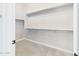 Walk-in closet features carpeted flooring and built-in shelving at 20615 W Daniel Pl, Buckeye, AZ 85396
