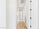 Bright hallway with light walls, wood-look tile flooring, and doorways leading to other rooms in the home at 20615 W Daniel Pl, Buckeye, AZ 85396