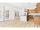 Open kitchen with stainless steel appliances, wood cabinets, an island, and access to the backyard at 20615 W Daniel Pl, Buckeye, AZ 85396