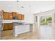 Bright kitchen featuring stainless steel appliances, wood cabinets, and a kitchen island at 20615 W Daniel Pl, Buckeye, AZ 85396