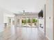 Spacious open-concept living area with wood floors, modern fireplace, and sliding doors to the patio at 20615 W Daniel Pl, Buckeye, AZ 85396