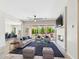 Inviting living room featuring stylish furniture, a cozy fireplace, and large sliding doors to the backyard at 20615 W Daniel Pl, Buckeye, AZ 85396
